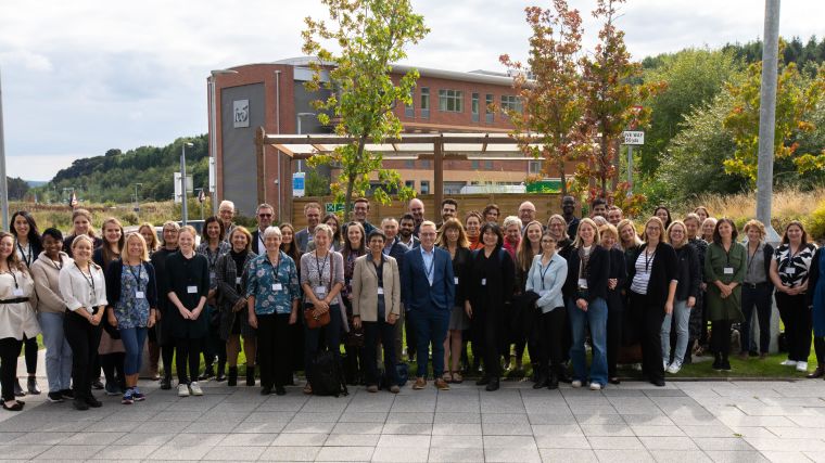 Group photo of attendees to the 2022 Annual Trainees Event. Taken outside the Denise Coates building, Keele University.
